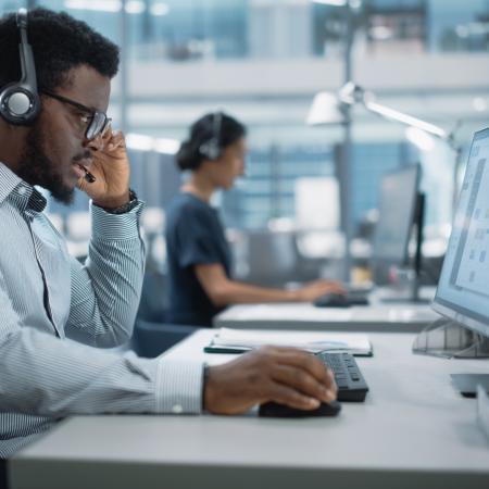 Person sitting at a desk in the middle of a phone call
